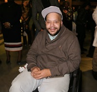 a man in a wheelchair smiling for the camera