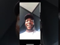 a man in a hat is talking on a phone