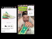 a man is showing a picture of a pair of sneakers